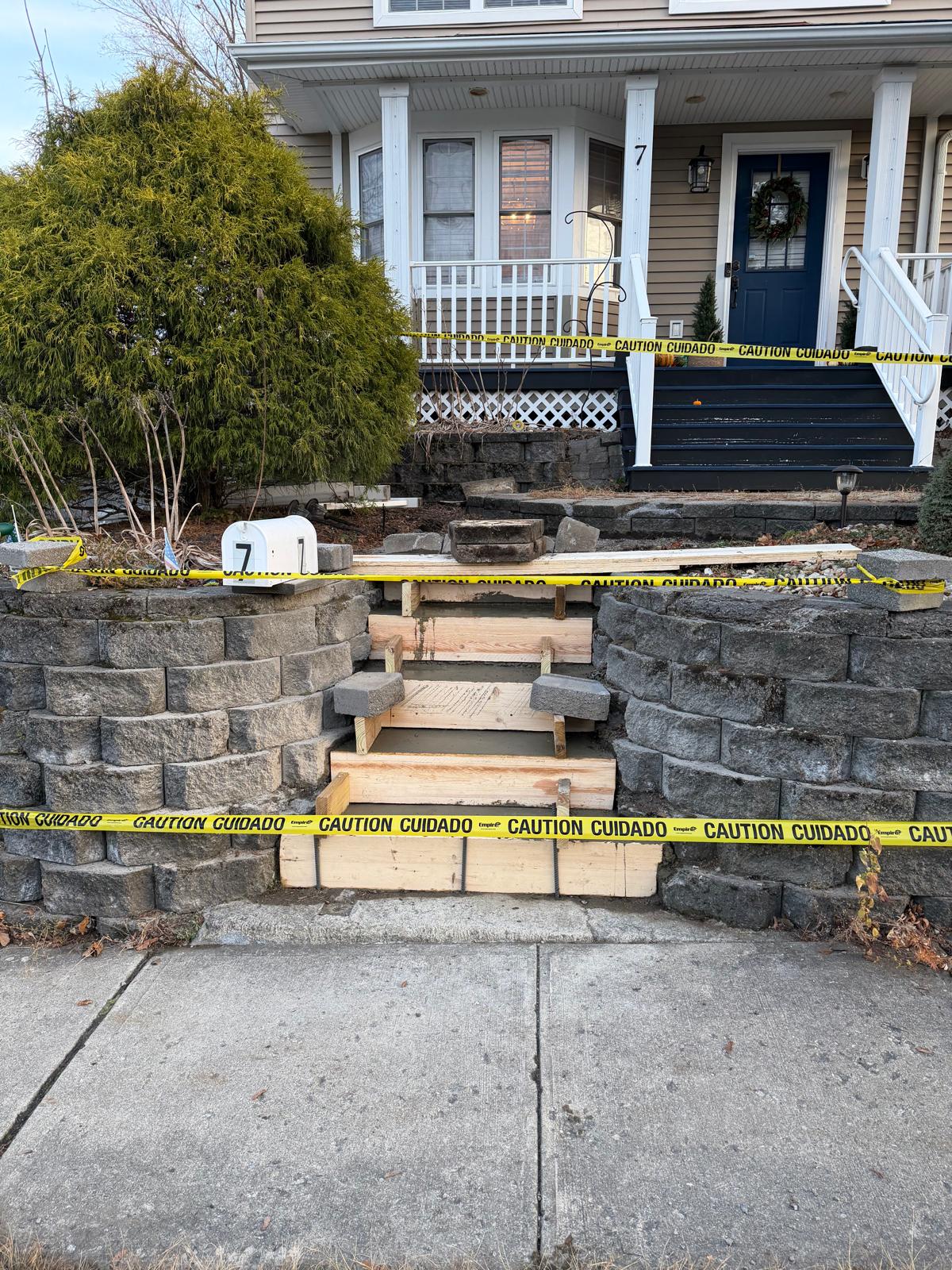 Existing steps showing wear and cracks before reconstruction. Masonry team preparing for complete replacement in Newton, NJ by Deluxe Construction.